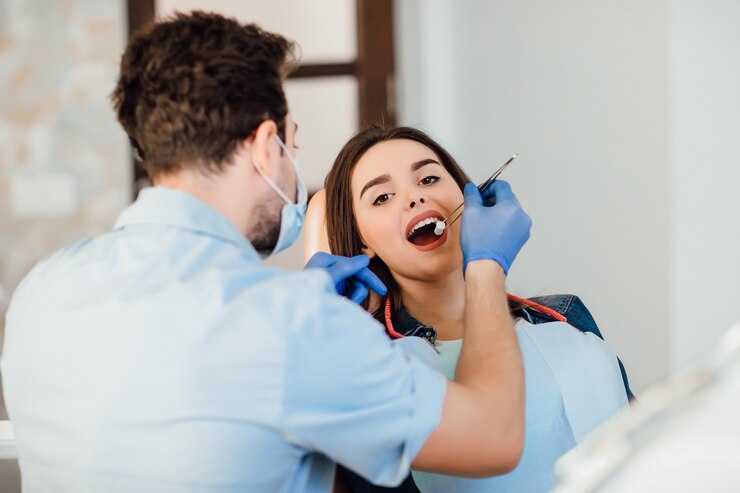 dentist-making-professional-teeth-cleaning-withb-cotton-female-young-patient-dental-office